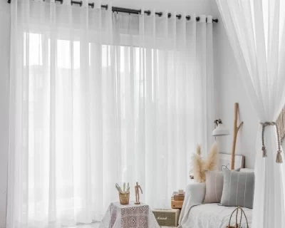 Awhitesheercurtainhangsinamodernlivingroom
